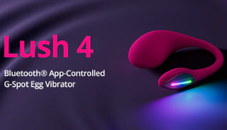 Lovense Lush 4 G-punktsvibrator i rosa med Bluetooth-styrning via app. Produkten är placerad på ett mörklila tyg med ett färgstarkt LED-ljus i änden.