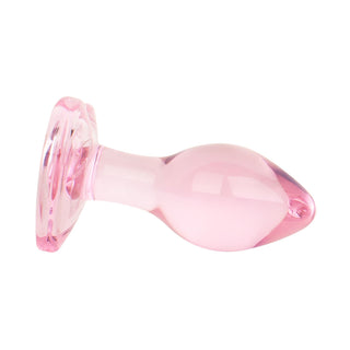 Heart Shaped Glass Buttplug 7 cm, en rosa analplugg i glas med hjärtformad bas, visas liggande på sidan mot en vit bakgrund - perfekt för temperaturlekar.