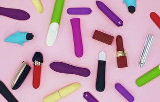 Färgglada bulletvibratorer i olika former och material liggandes utspritt på en rosa bakgrund, perfekt för mobilvisning av bulletvibrator-kategorin