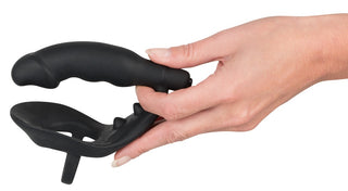En hand håller Black Velvets Penisring & Buttplug mot en vit bakgrund.