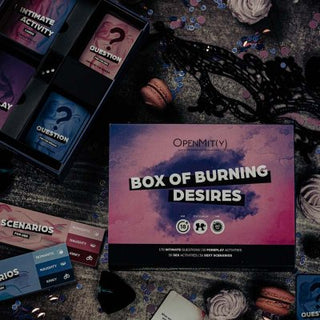 The Box Of Burning Desires, en mystisk spellåda omgiven av kort, macarons och en maskeradmask, lovar intimitet och romantik vid varje tur.