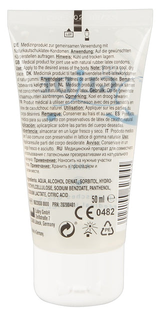 En 50 ml tub med Just Glide Anal Glidmedel, ett vattenbaserat glidmedel för sömlösa applikationer, innehåller flerspråkiga instruktioner och detaljer, vitt lock och produktkoder.