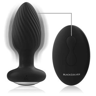 Black&Silver Wells Fjärrstyrd Buttplug är en svart, kroppssäker silikonplugg med en strukturerad design och fjärrkontroll. Den har en slät finish, en basladdningsport och en oval fjärrkontroll med två huvudknappar för enkel användning.
