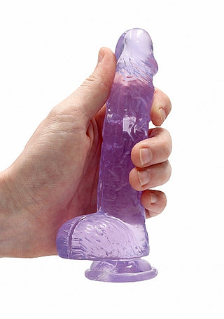 En hand håller Lila Dildo Med Sugpropp 17cm, en premium dildo av TPE-material med en sugbas i en lila genomskinlig design.