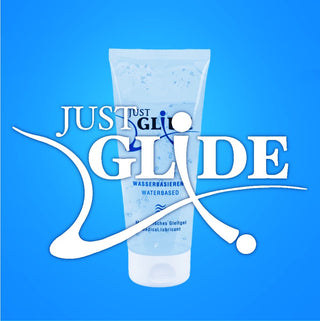 Just Glide vattenbaserat glidmedel i genomskinlig tub på blå bakgrund