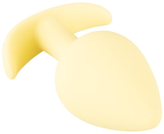 Cuties Mini Buttplug Gul är ett gult silikonplagg med ett brett handtag och konisk spets, som matchar formen på en knölig buttplug.