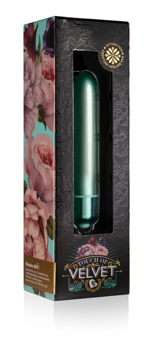Velvet Aqua Bulletvibrator är ett grönt cylindriskt föremål i en blommönstrad låda märkt Touch of Velvet.