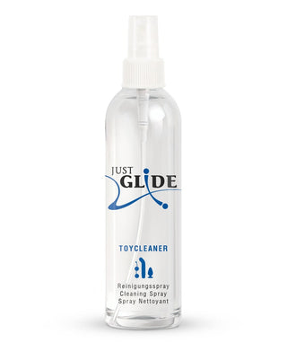 Just Glide Rengöringsspray 250ml är en klar sprayflaska med engelsk, tysk och fransk text på etiketten. Denna hudvänliga sexleksaker rengöringsspray erbjuder säker och effektiv rengöring som en del av ett pålitligt produktsortiment.
