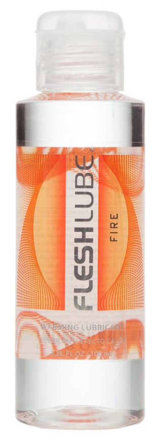 Transparent flaska med Fleshlube Fire värmande glidmedel med orange etikett, avsedd för användning med sexleksaker.