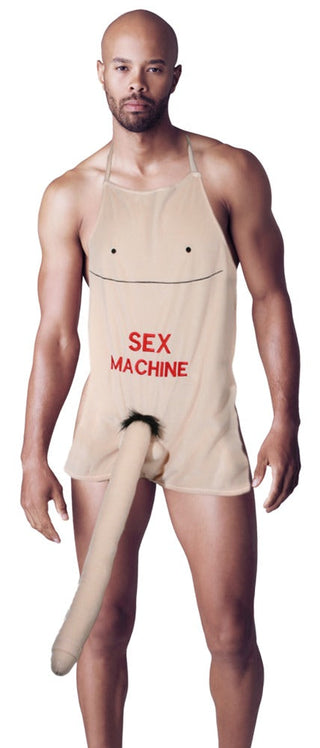 En person står mot en vit bakgrund, klädd i Roligt Förkläde med Penis, med fet "Sex Machine"-text och en lekfull, utskjutande plyschpenis.