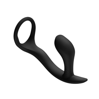 Svart prostatamassagerare i silikon med integrerad penisring, med ergonomisk form, avbildad mot en vit bakgrund.