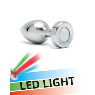 Rimba Buttplug Med LED har en metallisk design med ett strålande LED-ljus som avger röda och gröna strålar. I basen sticker "LED LIGHT"-texten ut mot en levande bakgrund av gröna, röda och blå nyanser, och erbjuder en lockande display med temperaturlek-tips.