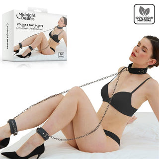 Svart halsband och fotbojor i veganskt läder från Midnight Desires, i enkel design. Förpackningen syns.