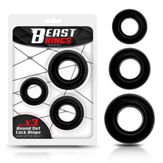 Beast Cockring Set 3-Pack innehåller tre svarta cirkulära ringar gjorda av kroppssäkra material. Dessa flexibla ringar visas både inuti och utanför sin förpackning mot en vit bakgrund.
