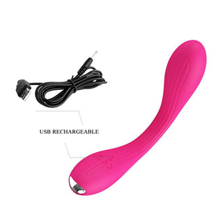 PrettyLove Yedda Bendable är en rosa C-formad vibrator för stimulering av G-punkten, visad med sin USB-laddningskabel och märkt som USB-laddningsbar.