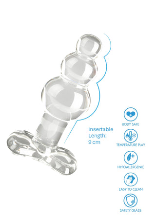 Analplugg i genomskinligt glas, 9 cm lång, med slät yta och en utvidgad bas. Allergivänligt material.