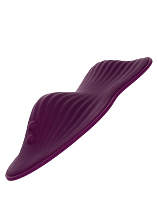 Lila, vågformad massager av silikon med två runda knappar, avbildad utan förpackning.