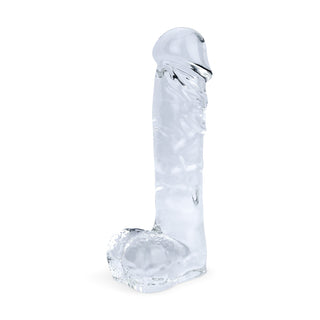 Genomskinlig glasdildo, 18 cm, slät design, tillverkad av högkvalitativt klart glas, avbildad i upprätt läge mot en enfärgad vit bakgrund.