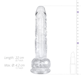 Jelly Dildo 19 cm Med Pung är en transparent, texturerad dildo som är idealisk för vaginal och anal stimulering, avbildad bredvid ett läppstift för storleksreferens.