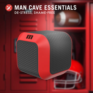 Slambox Masturbator i rött och svart sitter framför skåp och fotbollsutrustning, märkt Man Cave Essentials: Avstressa, skämmas inte. Njut av handsfree njutning med roterande stimulering för ultimat avkoppling.