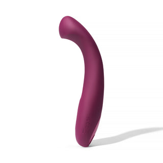 Dame Arc G-punktsvibrator är en böjd, lila silikonvibrator som står upprätt på en vit bakgrund, utformad för klitorisstimulering och är vattentät för mångsidig njutning.