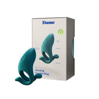 Dame Hug Adjustable Cock Ring, tillverkad av kroppssäker silikon, visas bredvid sin Dame-box på en vit bakgrund.
