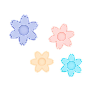 Teazers Vagina Dilator Set 4 Delar innehåller fyra pastellfärgade, blomformade dilatatorer med cirkulärt centrum, utformade för träning av bäckenbottenmusklerna och stöd för personer som upplever vaginism.