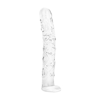 En genomskinlig dildo av texturerat glas, 19 cm lång, med upphöjda räfflor, som står upprätt på en vit yta.