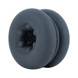 Tre mörkgrå penisringar i silikon med texturerade inre bulor, visas på en vit bakgrund.