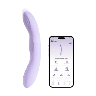 En G-punktsvibrator i lavendelfärgad silikon med böjd design och tryckfunktion visas bredvid en smartphone.