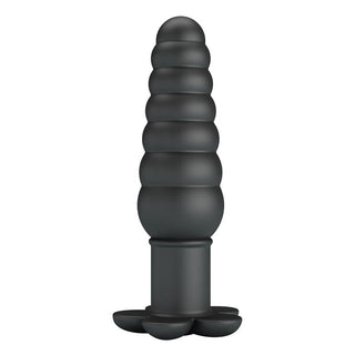 Analplugg i svart silikon med räfflad bas, fotograferad mot en vit bakgrund.