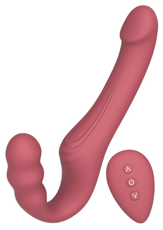 Rosa strap-on-vibrator med två ändar och utan axelband, tillverkad av silikon, med strukturerat handtag, inklusive fjärrkontroll med tre knappar.