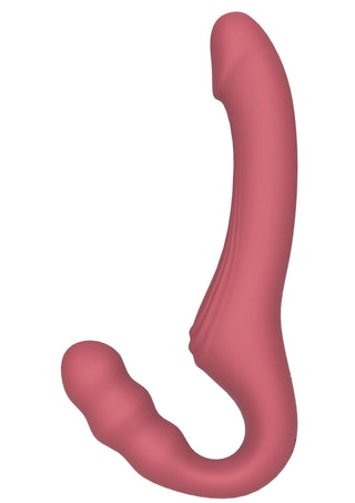 Rosa strap-on-vibrator i silikon utan axelband, med en böjd form och både släta och strukturerade ytor.
