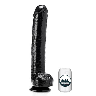 Summum Dildo Super John 44 cm står upprätt bredvid en vanlig läskburk för att visa skillnaden i storlek.