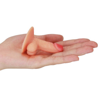 En liten, kötttonad Penis Mobilhållare, gjord av premium kvalitativt silikon, vilar lekfullt på en öppen hand.