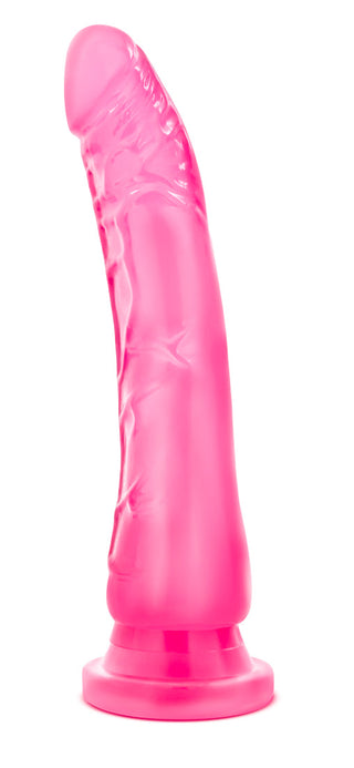 Rosa silikon-dildo med realistisk design, sugkopp och harnessbas, fotograferad mot vit bakgrund.