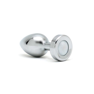Ett glänsande metallobjekt, som heter Rimba Buttplug Med LED, har en droppform i ena änden och en cirkulär platt bas på den andra, mot en vanlig vit bakgrund.