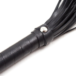 Närbild av Latetobed BDSM Flogger 69 cm handtag i svart läder med metallbeslag och silvernitar, med flera lädersträngar.