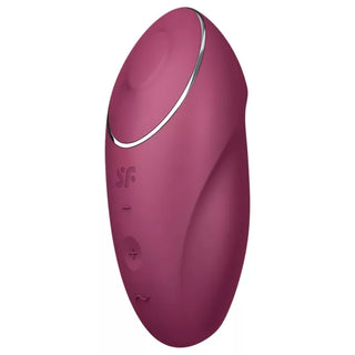 Liten rödbrun vibrator med knappar och en metallisk accent nära toppen, tillverkad av slätt material.