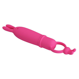 Rosa bulletvibrator i silikon med ringhandtag och två öronformade förlängningar, mot vit bakgrund.
