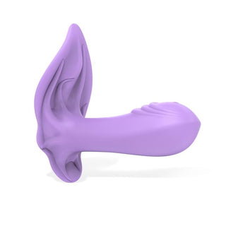 Engily Ross Donnyel Trosvibrator, tillverkad av premium silikon, är en lila abstrakt skulptur som liknar en blommande form med kronbladsliknande förlängningar och en lökformig ände mot en vit bakgrund.
