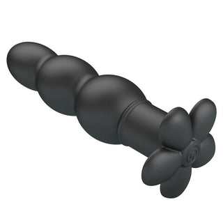 Analplugg i svart silikon med pärlformad design, blomformad bas och vibrationsfunktion.