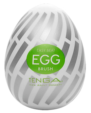 Vit och grå Tenga Egg Brush med grön etikett "Easy Beat Egg Brush", utformad som ett praktiskt engångsägg för nöjesbruk från Tenga New Adult Concept.