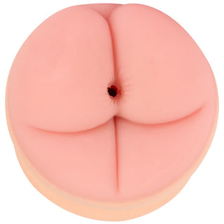 2in1 Buttplug Extension är en rund, rosa silikonleksak med fördjupningar och ett litet hål i mitten, med en abstrakt design.