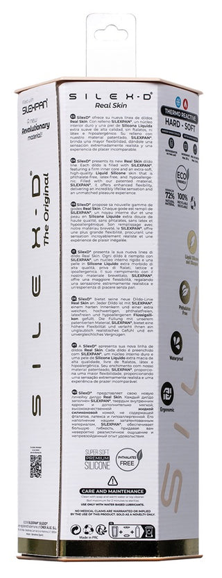 Hög, cylindrisk vit låda med svart och guldfärgad text, symboler och instruktioner på baksidan – utformad för att hysa SilexD 7" Real Skin Dildo.