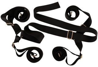 Ett set med fyra svarta nylonremmar med metallspännen från ”Under the Bed Restraint Kit”, avbildade mot en vit bakgrund.