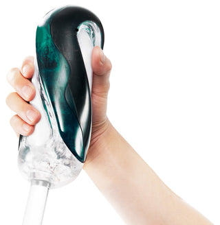Genomskinlig mörkgrön Tenga Flip 360 Masturbator tillverkad av klar plast med texturerad insida, visad på en vit bakgrund.