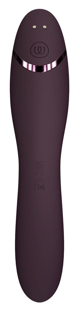 Womanizer OG är en mörklila vibrerande massagestav med Pleasure Air™-teknologi, med en elegant, böjd design och en glänsande metallring nära toppen.