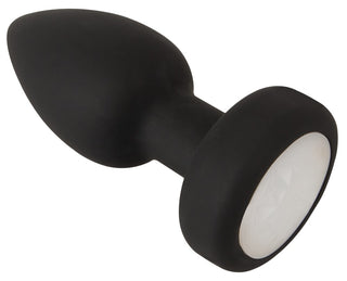 LED Buttplug med Vibration är en sorts silikontopp med tillspetsad spids, rund bund och vit ædelstensdetalje - lägger till extra spänning med LED-belysning och vibration för ett dragende lys- och følelsesspil.