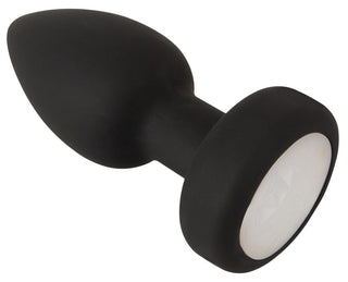 LED Buttplug med Vibration är en sorts silikontopp med tillspetsad spids, rund bund och vit ædelstensdetalje - lägger till extra spänning med LED-belysning och vibration för ett dragende lys- och følelsesspil.